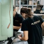 technician repairing machinery in workshop